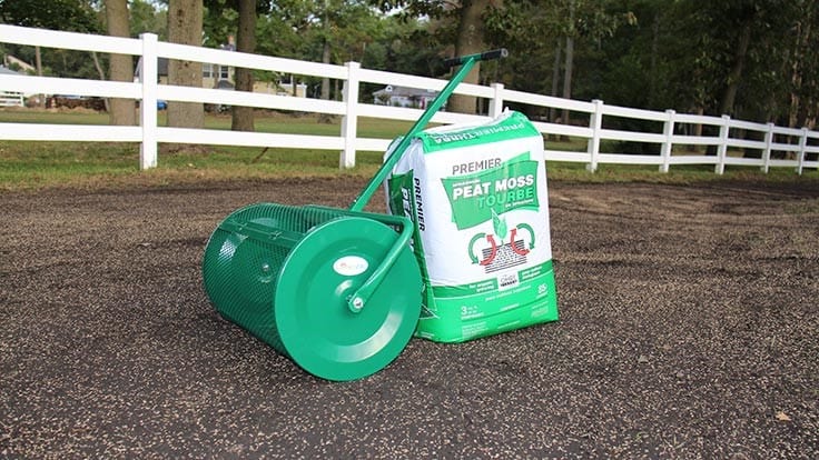 Topdressing roller outlet